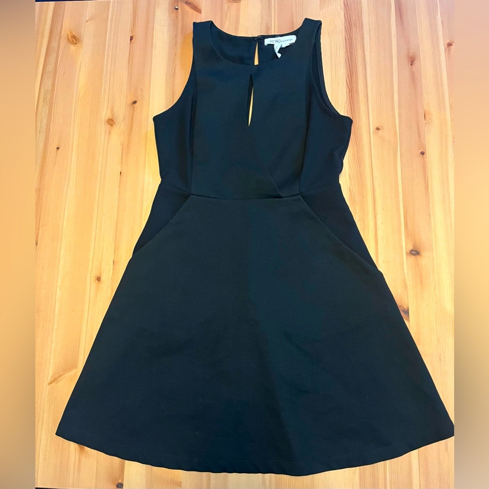 BCBGeneration Size 2 black mini peplum dress.